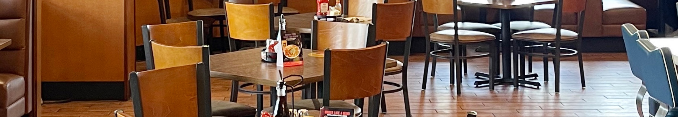 Denny&rsquo;s dining room with wooden tables and chairs